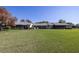 A spacious backyard with well-manicured lawn and screened lanai, ideal for outdoor relaxation at 40 Gretchen Ct, Oldsmar, FL 34677