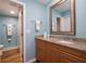 Stylish bathroom featuring a granite countertop vanity and an open doorway to the toilet and shower area at 40 Gretchen Ct, Oldsmar, FL 34677