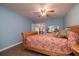 Comfortable bedroom with a wooden bed frame, ceiling fan, and views of a dresser and an adjacent space at 40 Gretchen Ct, Oldsmar, FL 34677
