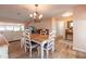 Open-concept dining area with wood-look flooring, chandelier, and view into living area with comfortable seating at 40 Gretchen Ct, Oldsmar, FL 34677