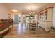 Inviting dining room offers chandelier, wood floors and a front door view to enjoy a relaxing space at 40 Gretchen Ct, Oldsmar, FL 34677