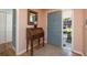 Welcoming entryway featuring hardwood floors, a stylish desk, and a view through to the front door at 40 Gretchen Ct, Oldsmar, FL 34677