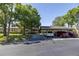 Well-maintained home exterior with covered parking, lush landscaping, and a neatly paved driveway at 40 Gretchen Ct, Oldsmar, FL 34677