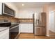 Modern kitchen featuring stainless steel appliances, white cabinets, granite countertops and modern fixtures at 40 Gretchen Ct, Oldsmar, FL 34677