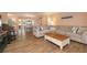 Spacious living room with cozy seating, a decorative wood coffee table, and ample natural light from the windows at 40 Gretchen Ct, Oldsmar, FL 34677