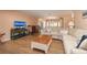 Inviting living room with wood-look floors, comfortable sectional sofa, and seamless flow to the dining area at 40 Gretchen Ct, Oldsmar, FL 34677