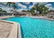 Sparkling community pool features ample lounge seating, umbrellas and a shallow end for children at 40 Gretchen Ct, Oldsmar, FL 34677