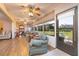 Light-filled sunroom with comfortable seating, ceiling fans, and large windows offering serene outdoor views at 40 Gretchen Ct, Oldsmar, FL 34677