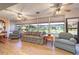 Relaxing sunroom with comfortable seating, ceiling fans, and expansive windows overlooking the lush backyard at 40 Gretchen Ct, Oldsmar, FL 34677