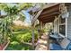 Charming covered patio with outdoor seating overlooking a lush, landscaped backyard at 4414 W El Prado Blvd, Tampa, FL 33629