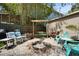 Cozy backyard fire pit area with pea gravel, a wood bench swing, and bamboo for added privacy at 4414 W El Prado Blvd, Tampa, FL 33629