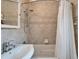 Tiled bathroom featuring a shower-over-tub with chrome fixtures and a white shower curtain at 4414 W El Prado Blvd, Tampa, FL 33629