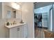 Bright bathroom with a vanity, mirror, and walk-in closet offering convenience and style at 4414 W El Prado Blvd, Tampa, FL 33629
