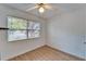 Bright bedroom with hardwood floors, a ceiling fan, and a large window overlooking the outdoors at 4414 W El Prado Blvd, Tampa, FL 33629