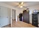 This bedroom features wood-look floors, a ceiling fan, and closet storage space at 4414 W El Prado Blvd, Tampa, FL 33629
