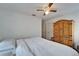 Bedroom featuring wood-look floors, a ceiling fan, closet, and large wooden wardrobe at 4414 W El Prado Blvd, Tampa, FL 33629