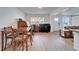 A dining room featuring wood-look floors, a table and chairs, a piano, and lots of natural light at 4414 W El Prado Blvd, Tampa, FL 33629