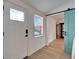 Welcoming entryway featuring a white door, sidelight window, and view into the living room with a barn door at 4414 W El Prado Blvd, Tampa, FL 33629