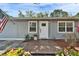 Charming home entrance with a cozy front porch and well-maintained landscaping at 4414 W El Prado Blvd, Tampa, FL 33629