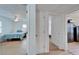 Hallway leading to bedrooms, showcasing flooring, neutral walls, and open doorways at 4414 W El Prado Blvd, Tampa, FL 33629