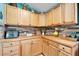 Charming kitchen boasts wood cabinets, stylish backsplash, butcher block countertops, and modern appliances at 4414 W El Prado Blvd, Tampa, FL 33629