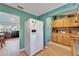 Eat-in kitchen with stainless steel refrigerator and views to an adjacent living area and dining space at 4414 W El Prado Blvd, Tampa, FL 33629