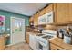 Galley kitchen featuring wooden cabinets, stainless steel appliances, and a gas range at 4414 W El Prado Blvd, Tampa, FL 33629