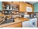 Efficient kitchen featuring stainless steel sink, butcher block countertops, and modern white appliances at 4414 W El Prado Blvd, Tampa, FL 33629