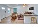Bright living room featuring a breakfast bar, blue sliding door, and a stylish ceiling fan at 4414 W El Prado Blvd, Tampa, FL 33629