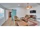 Comfortable living room features a unique blue sliding door and a modern ceiling fan at 4414 W El Prado Blvd, Tampa, FL 33629