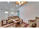 Comfortable living room with a tan couch, wood coffee table, and a turquoise barn door at 4414 W El Prado Blvd, Tampa, FL 33629
