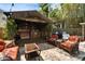 Outdoor tiki bar featuring a thatched roof, seating, and a paver patio, perfect for entertaining guests at 4414 W El Prado Blvd, Tampa, FL 33629