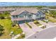 Aerial view of the townhouses showcasing their architectural design, garages, and landscaping at 4663 Almada Ln, Wesley Chapel, FL 33543