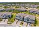 Beautiful aerial shot of the community showcasing multiple townhomes and surrounding green spaces at 4663 Almada Ln, Wesley Chapel, FL 33543