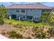 Rear exterior view of the townhouse showcasing patios and landscaped backyard at 4663 Almada Ln, Wesley Chapel, FL 33543