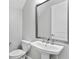 Cozy bathroom features a modern vanity with a stylish mirror and a white toilet at 4663 Almada Ln, Wesley Chapel, FL 33543