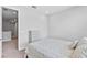 Bright bedroom featuring neutral walls, a comfortable bed, and a chest of drawers at 4663 Almada Ln, Wesley Chapel, FL 33543