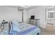Comfortable bedroom with a patterned bedspread and access to an ensuite bathroom at 4663 Almada Ln, Wesley Chapel, FL 33543