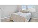 Bright bedroom with a comfortable bed, neutral bedding, and natural light from large windows at 4663 Almada Ln, Wesley Chapel, FL 33543