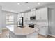 Bright kitchen featuring a large island with stainless appliances and gas range at 4663 Almada Ln, Wesley Chapel, FL 33543