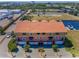 Stunning aerial view of a multi-story residence with a tile roof, landscaping, and a golf course nearby at 47 W Morgan St, Tarpon Springs, FL 34689