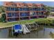 Aerial view of the property with a boat lift, dock, and townhomes overlooking the water at 47 W Morgan St, Tarpon Springs, FL 34689