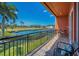 This covered balcony overlooks a serene pond and lush landscaping, a perfect spot for relaxing outdoors at 47 W Morgan St, Tarpon Springs, FL 34689