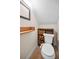 Powder room with wood-look tile, custom shelving and drawers, and an updated mirror at 47 W Morgan St, Tarpon Springs, FL 34689