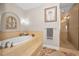 Relaxing bathroom features a soaking tub and glass-enclosed shower at 47 W Morgan St, Tarpon Springs, FL 34689