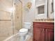 This bathroom features glass enclosed tiled shower, brown cabinets, and granite countertop at 47 W Morgan St, Tarpon Springs, FL 34689