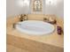 Bathroom featuring tiled tub with tile surround and fixtures at 47 W Morgan St, Tarpon Springs, FL 34689
