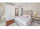This bedroom has a bed with a padded headboard, neutral walls, and wood floor at 47 W Morgan St, Tarpon Springs, FL 34689
