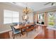 Elegant dining room with hardwood floors, chandelier, modern chairs, and water views from balcony at 47 W Morgan St, Tarpon Springs, FL 34689
