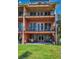 Three-story home with balconies and outdoor patio featuring a table, chairs, and grill on the back porch at 47 W Morgan St, Tarpon Springs, FL 34689